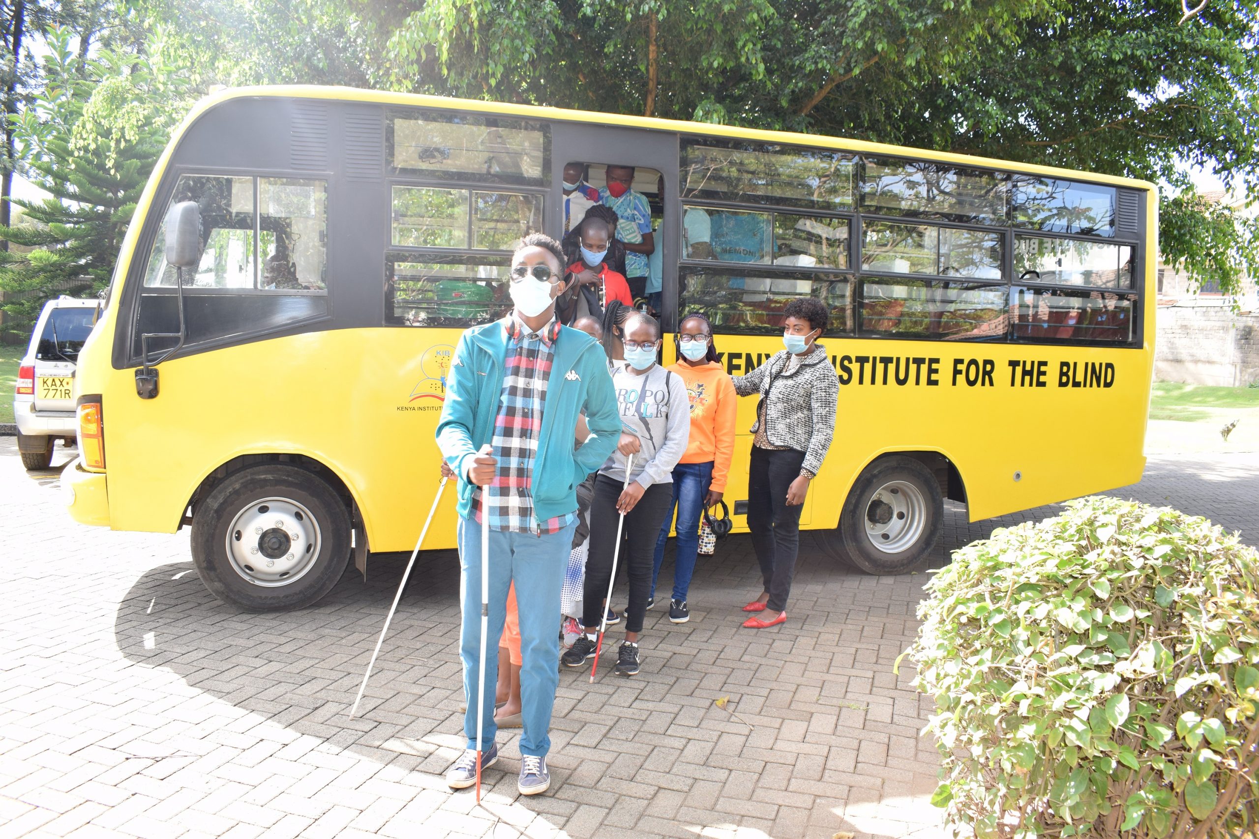 visually impaired students alighting from a school bus